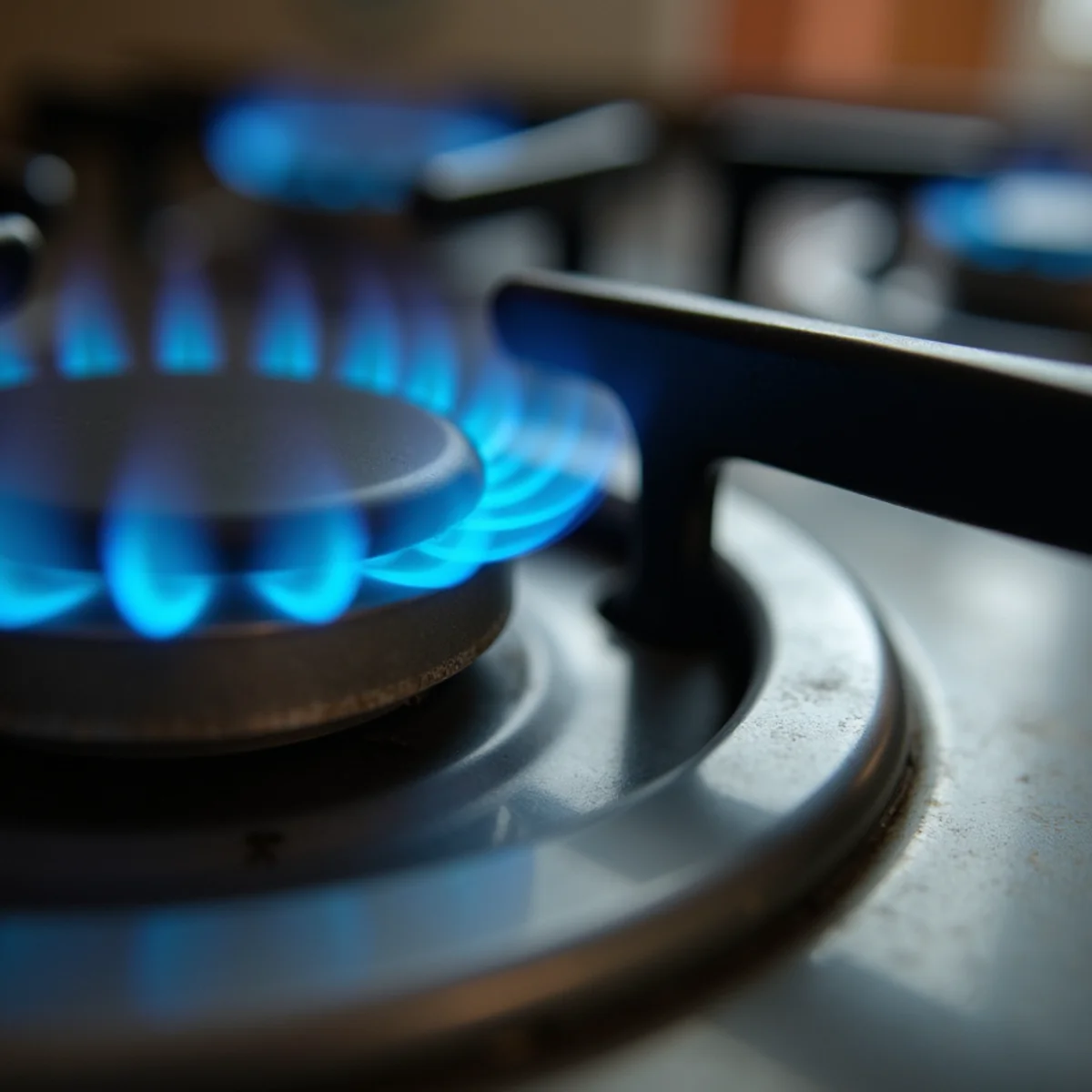 Blue pilot flame illuminating thermocouple tip in residential gas water heater